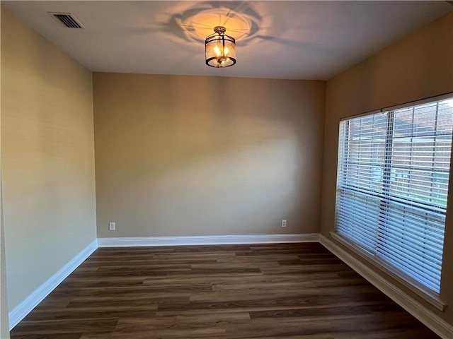 spare room with dark wood-type flooring