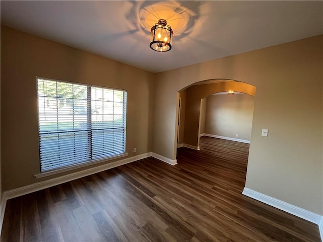 spare room with dark wood-type flooring