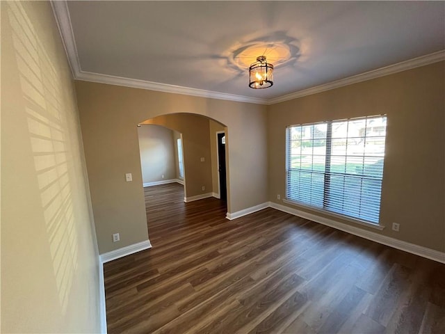 spare room with crown molding and dark hardwood / wood-style flooring