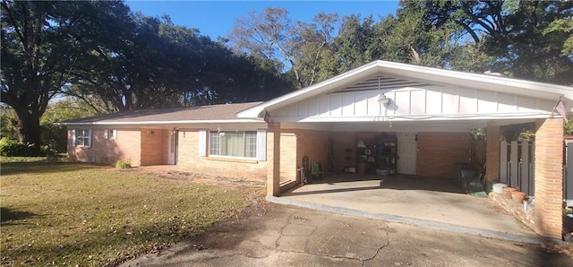 view of front of house with a front yard and a carport