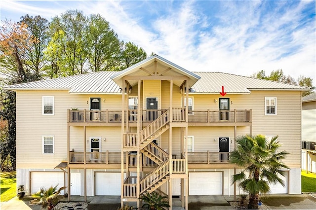 back of house featuring a balcony and a garage