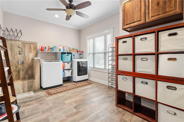 laundry room with ceiling fan, ornamental molding, light hardwood / wood-style flooring, cabinets, and separate washer and dryer