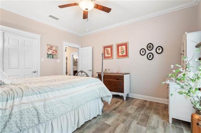 bedroom featuring ornamental molding, wood-type flooring, and ceiling fan