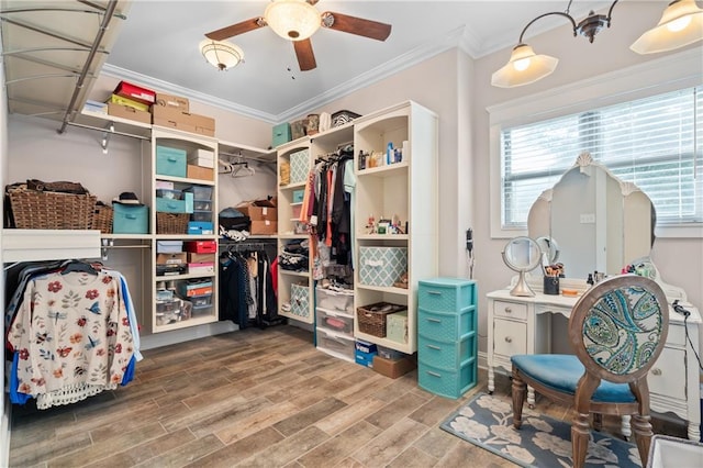 walk in closet featuring wood-type flooring and ceiling fan