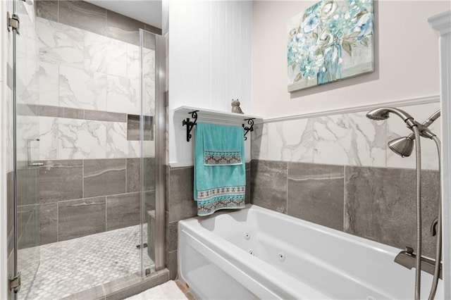 bathroom featuring plus walk in shower and tile walls