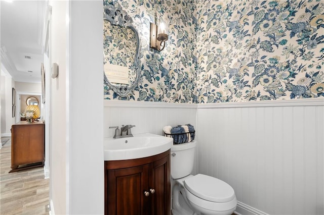 bathroom featuring vanity, hardwood / wood-style floors, and toilet