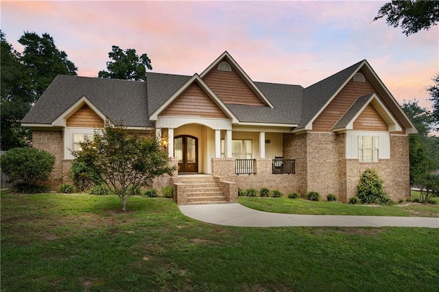 craftsman-style home featuring a lawn and covered porch