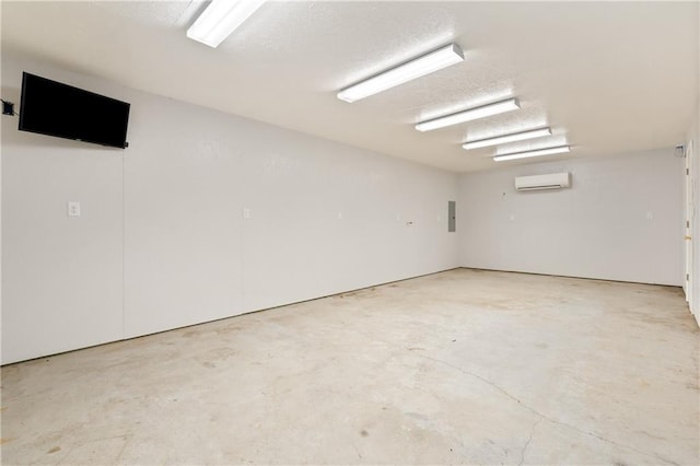 empty room featuring electric panel, concrete floors, and a wall mounted AC