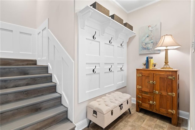 mudroom with crown molding and hardwood / wood-style floors