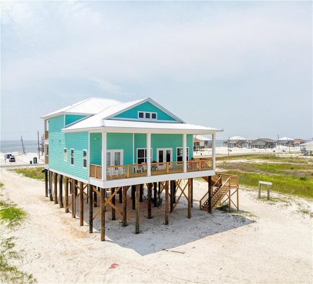 rear view of property featuring a porch and a water view