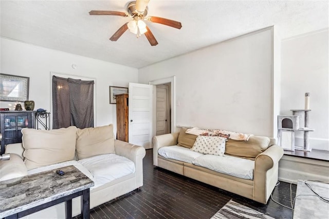 living room with dark wood-type flooring and ceiling fan