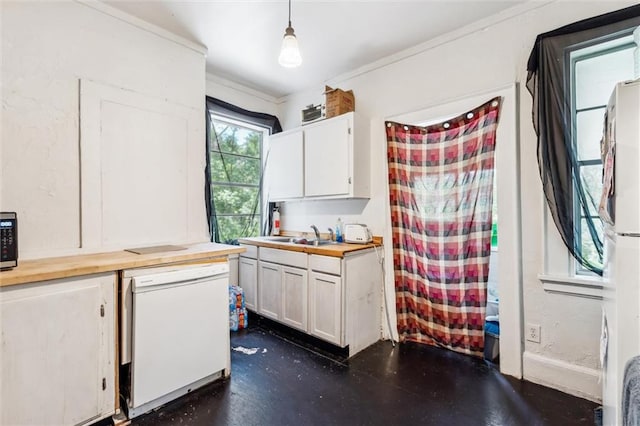 kitchen featuring white appliances, white cabinets, decorative light fixtures, wooden counters, and ornamental molding