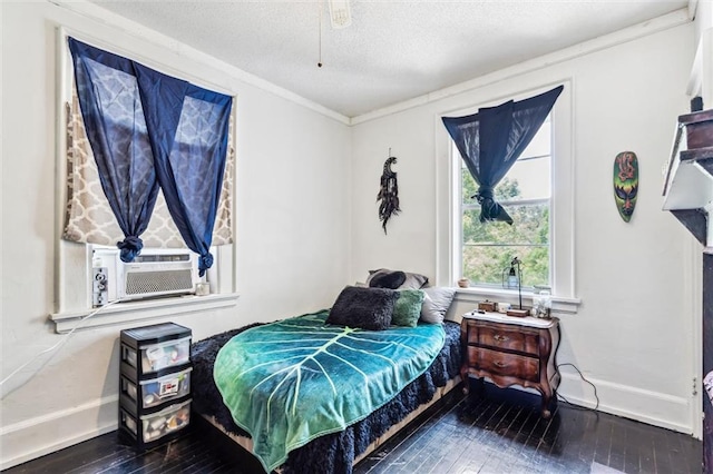 bedroom featuring crown molding, a textured ceiling, dark wood-type flooring, and cooling unit