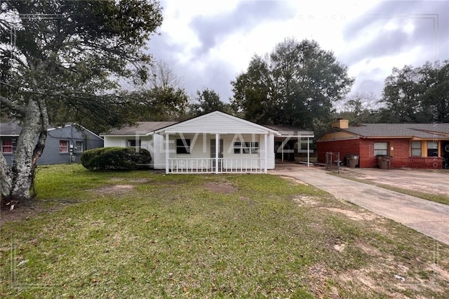 ranch-style house with a carport, covered porch, and a front yard