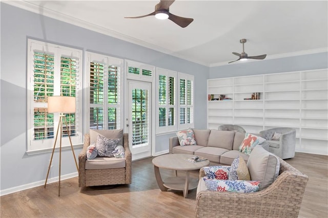 living room featuring hardwood / wood-style flooring, ceiling fan, and crown molding