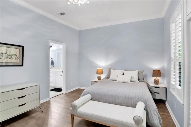 bedroom featuring dark hardwood / wood-style flooring, ensuite bath, and ornamental molding