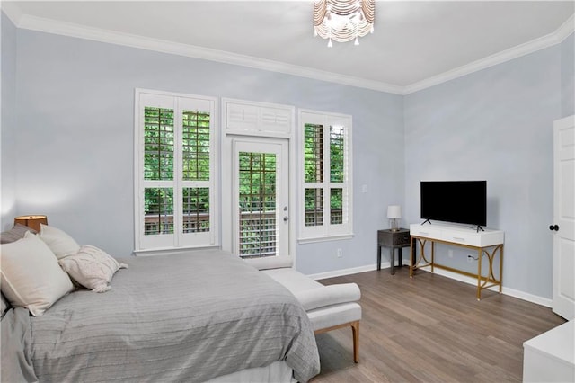 bedroom with access to exterior, hardwood / wood-style floors, a notable chandelier, and ornamental molding