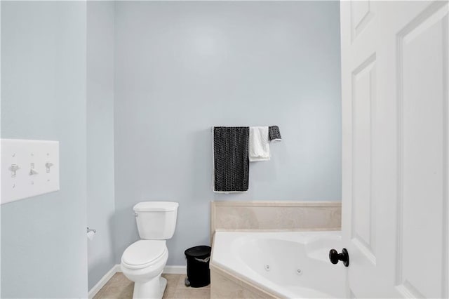 bathroom featuring toilet, tile patterned floors, and tiled tub