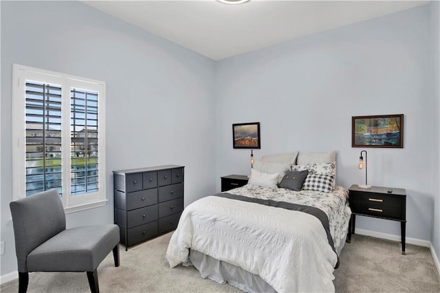 bedroom with multiple windows and light carpet