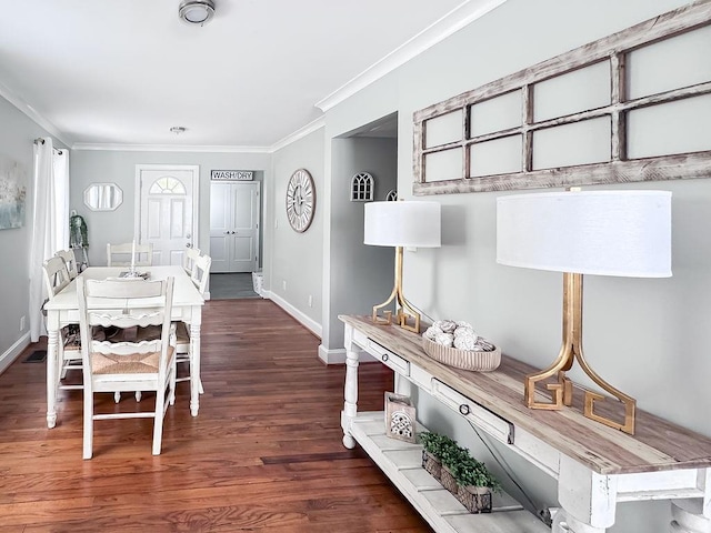 dining area featuring baseboards, ornamental molding, and wood finished floors