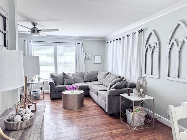 living room featuring wood finished floors, crown molding, baseboards, and ceiling fan