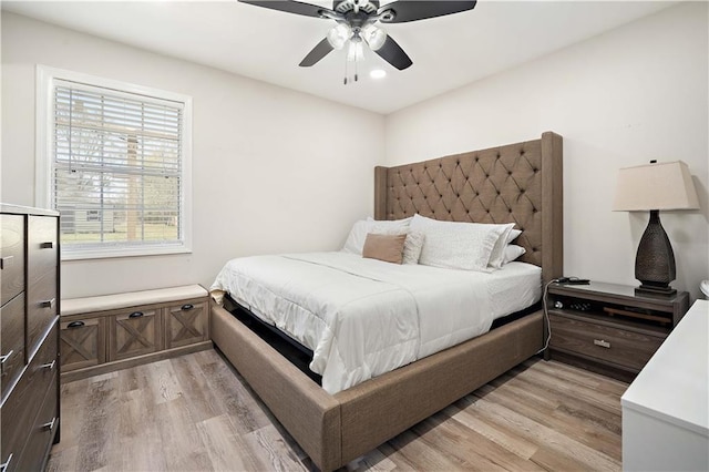 bedroom with light wood-style flooring and ceiling fan