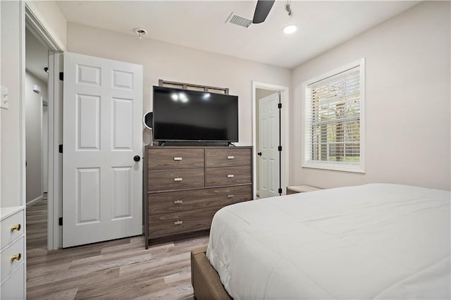 bedroom with visible vents, light wood finished floors, and ceiling fan