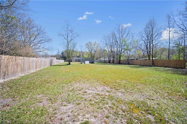view of yard with an outbuilding and a fenced backyard