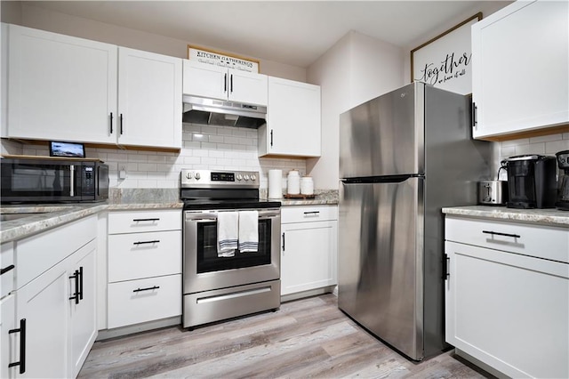 kitchen with under cabinet range hood, white cabinetry, stainless steel appliances, and light wood-type flooring