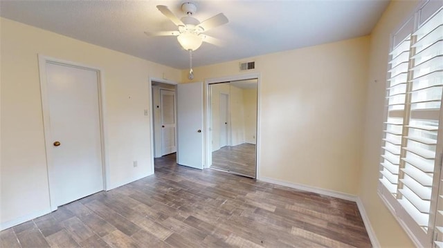 4009 Old Shell Rd Unit D13, Mobile, AL 36608 - unfurnished bedroom featuring a closet, ceiling fan, and dark hardwood / wood-style flooring