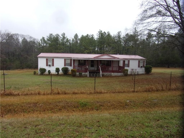 manufactured / mobile home with a front yard and a porch