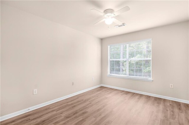 unfurnished room featuring ceiling fan and hardwood / wood-style floors