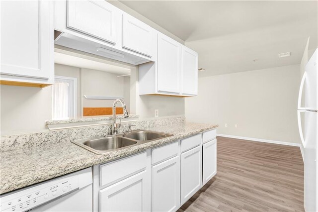 kitchen with sink, light hardwood / wood-style flooring, white cabinetry, and white appliances