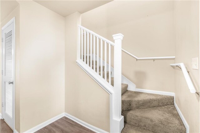 stairway with hardwood / wood-style flooring