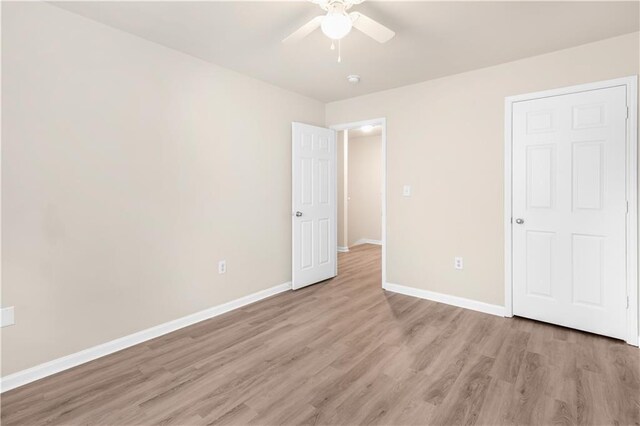 unfurnished bedroom with ceiling fan and wood-type flooring