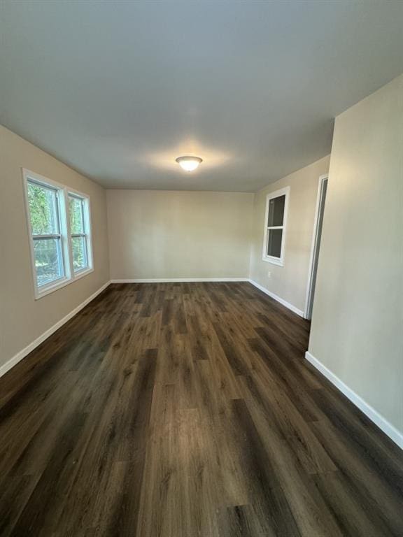 empty room with dark wood-type flooring