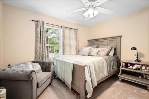 bedroom with ceiling fan and light colored carpet