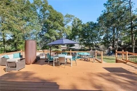 wooden terrace featuring outdoor lounge area