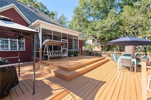 wooden deck with a sunroom