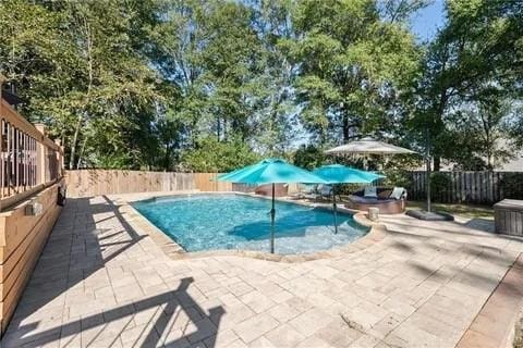 view of swimming pool with a patio area