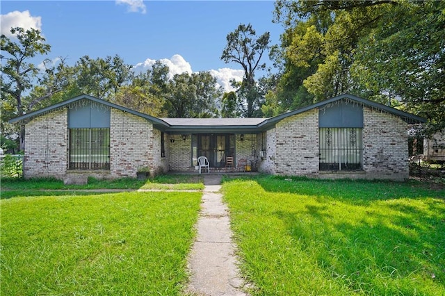 ranch-style house with a front lawn