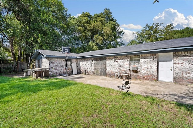 rear view of house featuring a lawn and a patio area