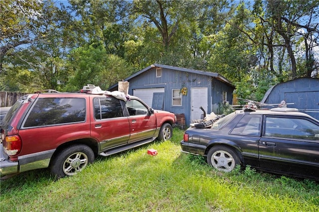 view of property exterior with a garage and an outbuilding