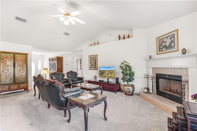 carpeted living room with ceiling fan, lofted ceiling, and a fireplace