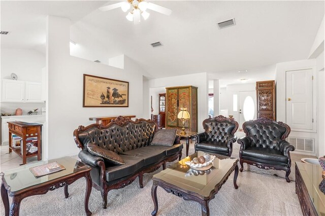 living room with ceiling fan and vaulted ceiling