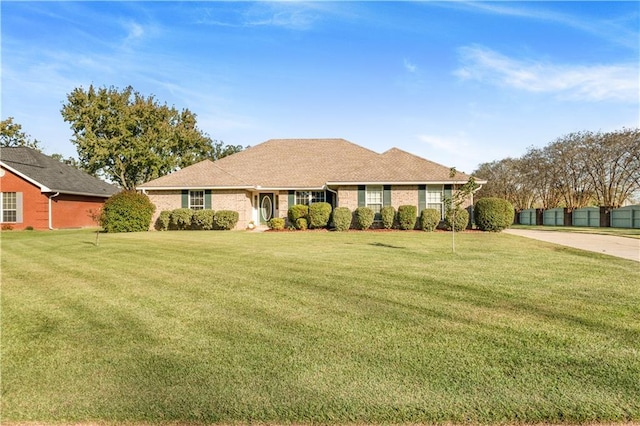 ranch-style home featuring a front yard