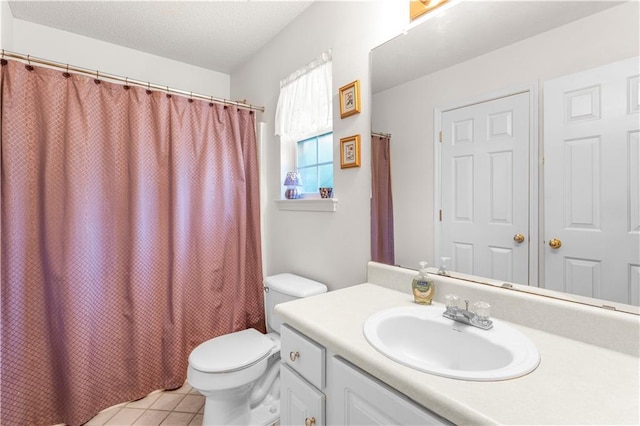 bathroom featuring toilet, tile patterned floors, and vanity