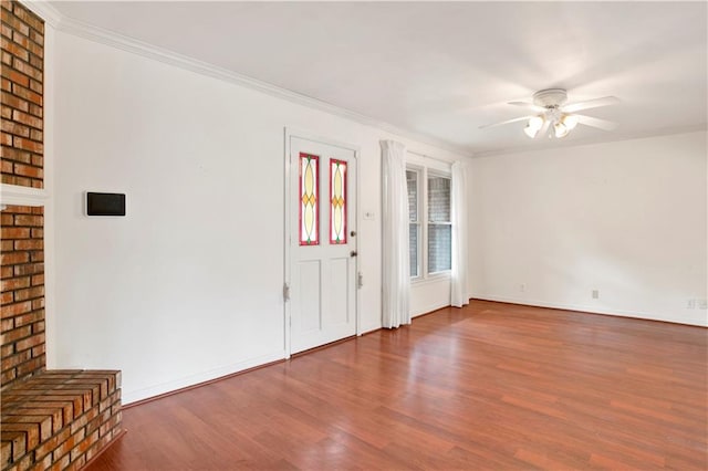 entryway featuring ceiling fan, dark hardwood / wood-style floors, and ornamental molding