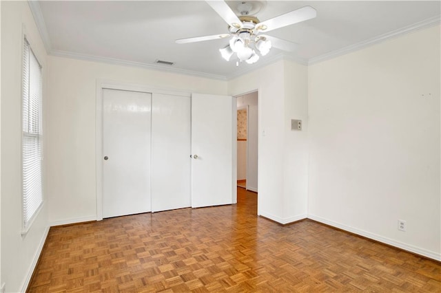 unfurnished bedroom featuring ornamental molding, multiple windows, and ceiling fan