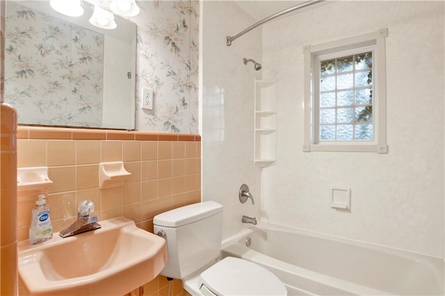 full bathroom with tile walls, shower / tub combination, toilet, and sink